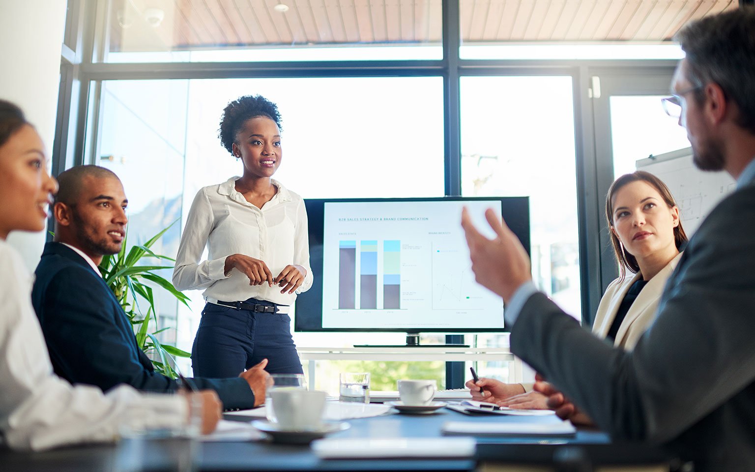 True digital transformation: going beyond "paperless" employees looking at a tablet in a meeting